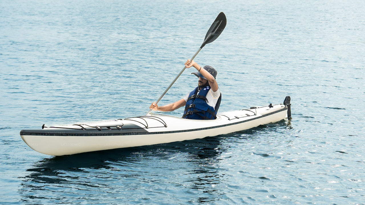 Person kayaking on a calm body of water